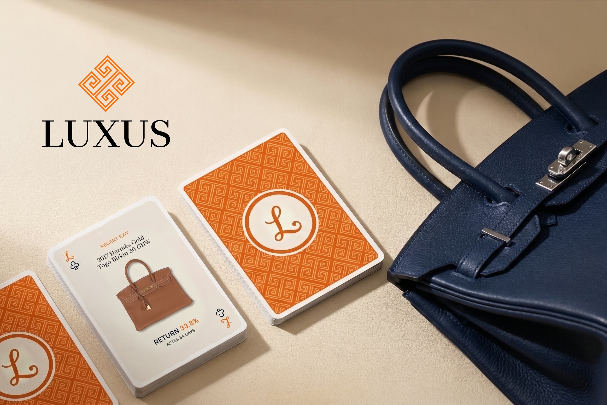Luxus cards on cream beside a navy Birkin