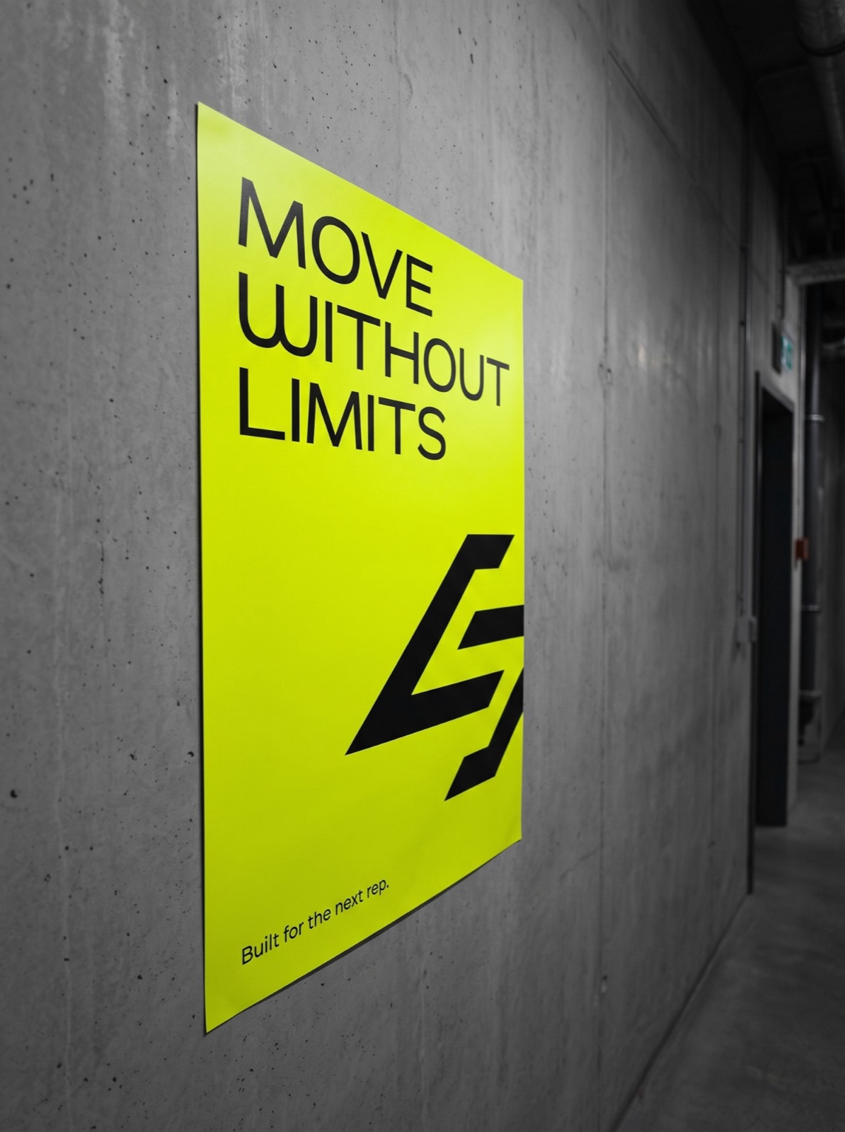 A lime poster with Move without limits on a concrete wall