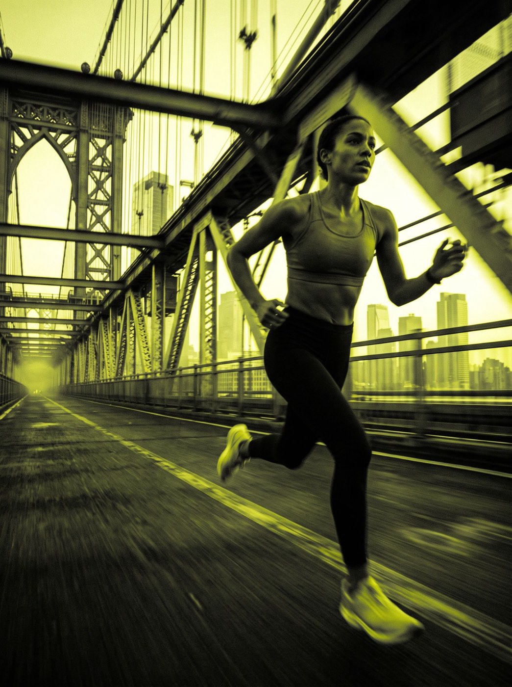 A woman running across a bridge at dawn