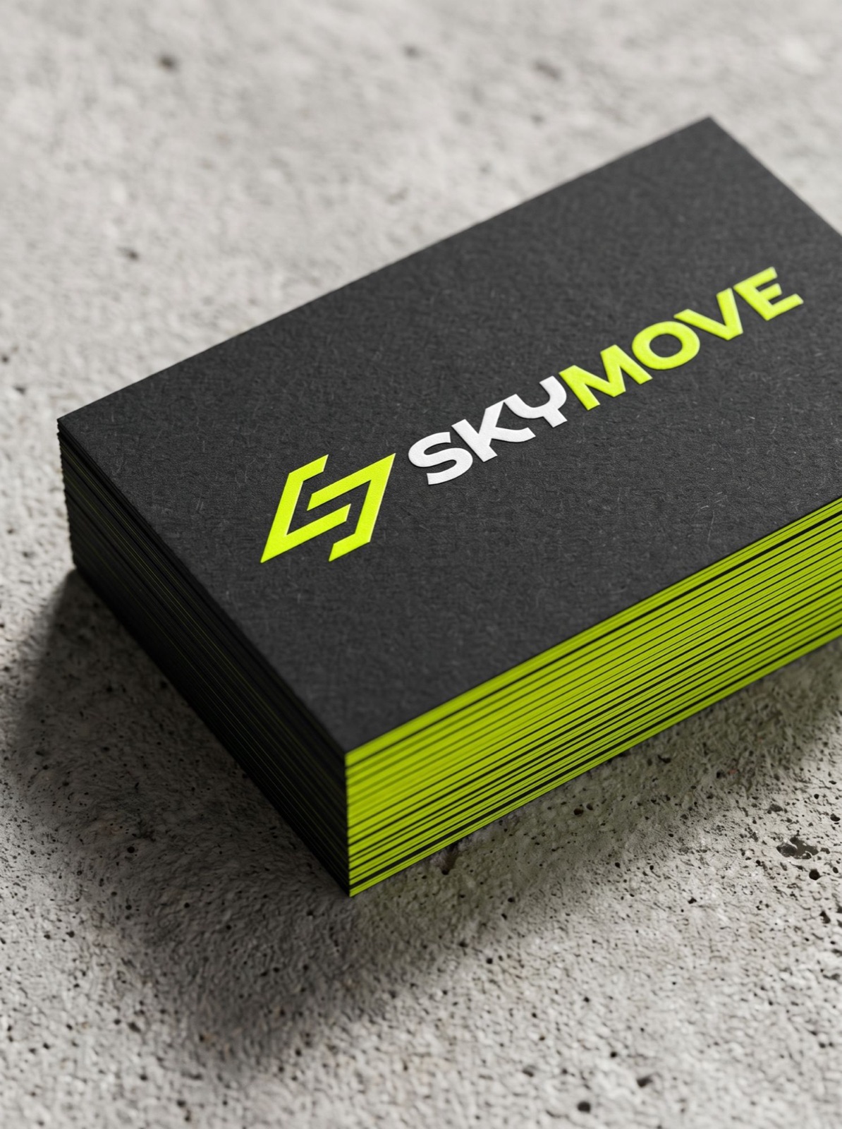 A stack of black business cards with lime edges